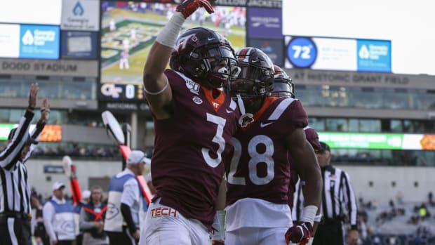 Virginia Tech Hokies defensive back Caleb Farley (3) celebrates after an interception return for a touchdown against the Georgia Tech Yellow Jackets in the second quarter at Bobby Dodd Stadium.